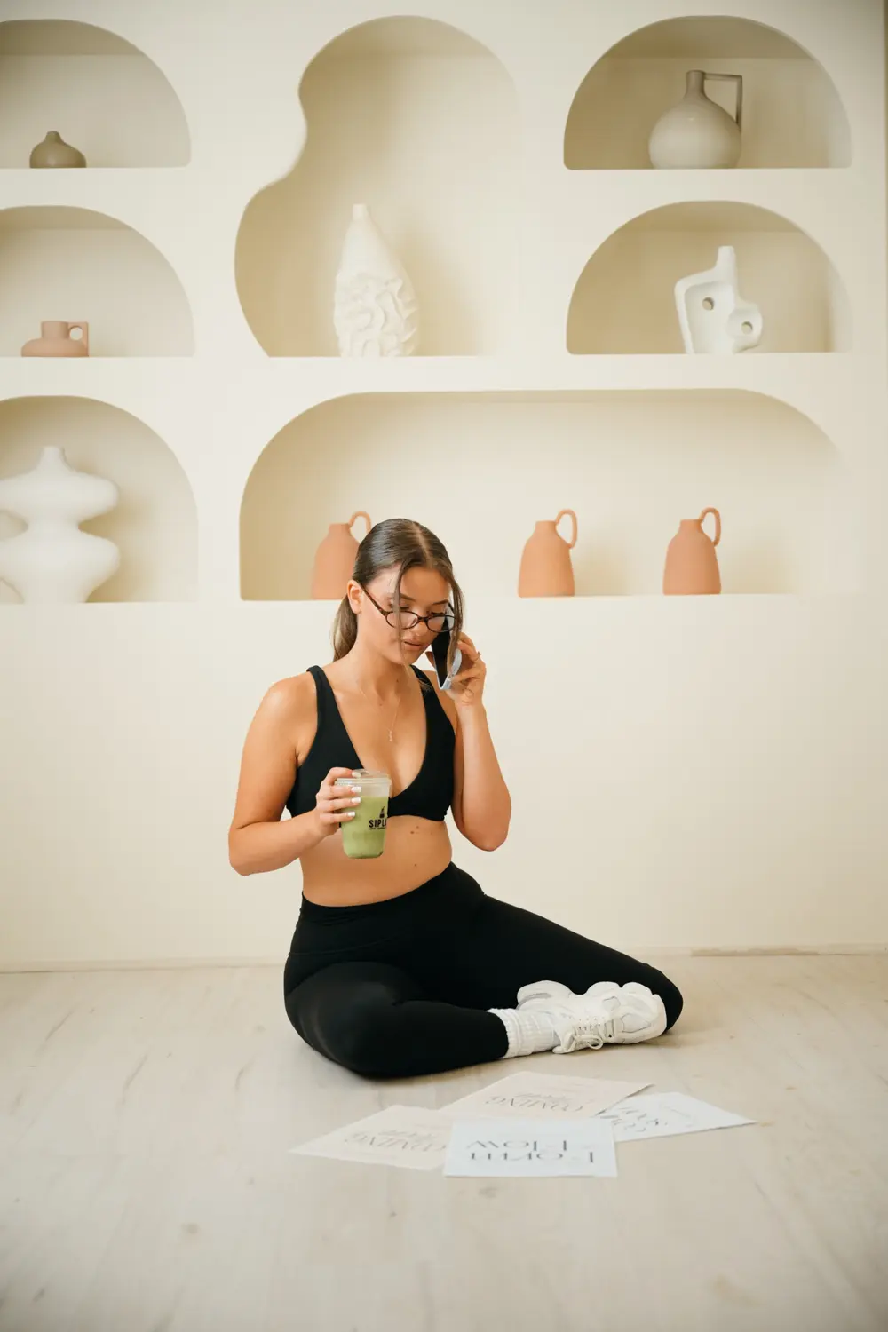 Form & Flow studio with arched shelves, ceramic vases and Form & Flow prints on the floor